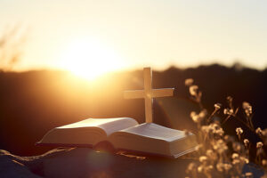pngtree-a-small-cross-sits-on-top-of-a-bible-image_10221124